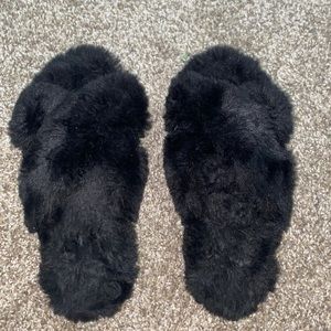 Black house slippers size 7.5 can fit an 8.5